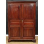 A 19th century mahogany wardrobe, moulded cornice above a pair of raised and fielded panel doors,
