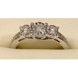 A diamond three stone ring, linear set with three diamonds, 9ct white gold shank, size N, 2.8g gross