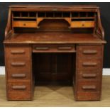 An early 20th century oak tambour roll top desk, 115cm high, 122cm wide, 76cm deep
