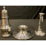 A silver sugar sifter, Birmingham 1930; a silver candlestick, Birmingham 1911; a silver inkwell,