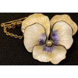 A gilt and enamel brooch as a pansy flower head, enamelled in white with accents of yellow and