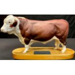 A Beswick Connoisseur model, Polled Hereford Bull, mounted on wooden base with plaque, 32cm long