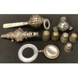 A silver and mother-of-pearl baby's rattle, Birmingham 1920; others; a silver thimble, Chester 1921;