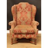 A William and Mary design wingback armchair, 117cm high, 89cm wide, the seat 54cm wide and 61cm deep