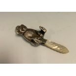 A novelty silver and mother-of-pearl baby's rattle, as bear, 12cm long, apparently unmarked, 20th