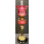 A late 19th century oil lamp, Wright & Butler, Birmingham, etched cranberry glass shade, cranberry