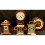 An Edwardian mahogany balloon mantel clock, white enamel dial with Roman numerals, twin winding