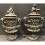 A pair of 19th century Classical Revival bronzed metal vases and covers, decorated in relief with