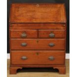 A George III oak bureau, fall front enclosing a well, small drawers and pigeonholes, above two short