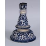 An Islamic tin glazed earthenware candlestick, signed Safi and inscribed in Arabic, 15cm high