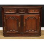 A 19th century French oak enfilade or buffet serving sideboard, slightly oversailing top with canted
