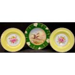 A pair of Royal Crown Derby cabinet plates, painted with flowers by Cuthbert Gresley, signed, yellow