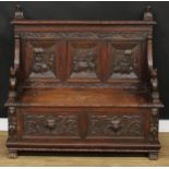 A 19th century Historicist Revival oak box settle or bench, rectangular back with herm finials above