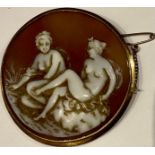 An Italian 18ct gold carved shell cameo brooch/pendant, with a couple of reclining females, marked
