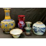 A Chinese ovoid vase, decorated with blue and white flowers on yellow ground, character marks to