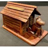 Treen - Folk Art - a prisoner of war novelty money box, as a dog and kennel, brass plaque