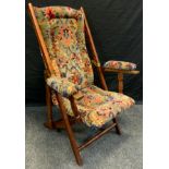 A late Victorian walnut campaign/steamer chair, slide pin action adjusters, floral upholstery, brass