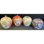 A pair of Chinese famille rose jars and covers decorated with traditional figures, lanterns and