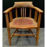 An early 20th century oak and elm desk chair, leather seat, indistinct marks