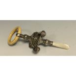 A George V silver, mother-of-pearl and bone baby's rattle, four bells, 13cm long, Crisford &