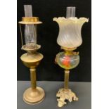 A Victorian brass and clear glass oil lamp, shaped tripod foot, frosted shade, another brass