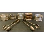 Three silver napkin rings, Birmingham 1927; another, 66.4g; silver plated tongs etc