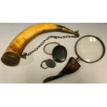 A horn hafted magnifying glass, 25cm long; a horn lens; another; a brass mounted horn, 28cm long (4)