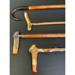 A 20th century waking stick, horn hafted, 90cm long; others, similar (4)