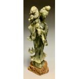 A Chinese spinach jade figure, Guan Yin, standing, pierced base, 11.5cm high