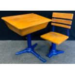 A child's school desk, cast iron base and slide action chair