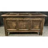 An 18th century oak blanket box, c.1760 three panelled top and front, carved lunette frieze, stile