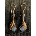 A pair of silver and yellow metal opal cabochon drop earrings, silver hook suspending a gold and