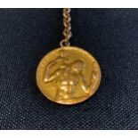 Betty Davis interest - a nine carat gold St. Christopher's medallion, 5.1g, suspended on a base