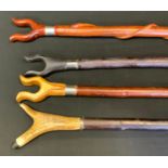 A 20th century waking stick, U shaped thumb rest, 132cm long; others (4)