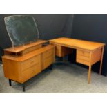 A retro 1960s Advance furniture dressing table, shaped mirror back above open shelf and an