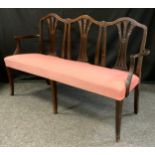 An Edwardian three-seat mahogany sofa, wheat-sheaf splats, tapered square legs, c. 1905.