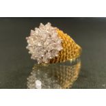 An 18ct gold diamond cluster ring, the central brilliant cut stone surrounded by four 0.2ct
