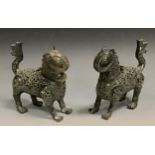 A pair of West African Benin bronze incense burners, in the form of Leopards, 18cm high