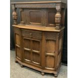 A mid 20th century oak Court Cupboard, single small cupboard door to top, above a short drawer and