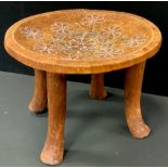 An African stool, painted dished seat, with traditional motifs, 30cm high, 39cm diameter