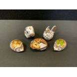 A Royal Crown Derby paperweight, Harvest Mouse, gold stopper; another, Sleeping Dormouse; Holly