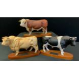 A Beswick Connoisseur model of a Hereford Bull; others Friesian Bull & Charolais Bull, wooden