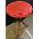 A late Victorian bobbin turned gypsy table, on tripod legs and associated top upholstered with a red