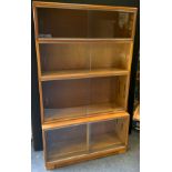 A Golden oak Minty stackable bookcase, four sections, sliding glass doors