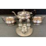 A John Somers Brazilian pewter cruet set on stand; silver plated three piece tea set