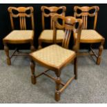 A set of four oak Art Deco style cloud back dining chairs, shaped back, turned fore legs, drop in