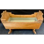 A 19th century pine cradle, c.1850 of typical form 50cm high 86cm wide 44cm deep