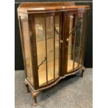 A 1940's mahogany china display cabinet, canted, break-front centre, glazed doors and sides,