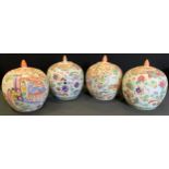 A pair of Chinese famille rose jars and covers decorated with traditional figures in the Garden,