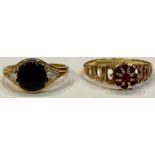 A 9ct gold onyx and diamond ring, size N, 2g; a 9ct gold and garnet ring, size P, marked 375, 1.